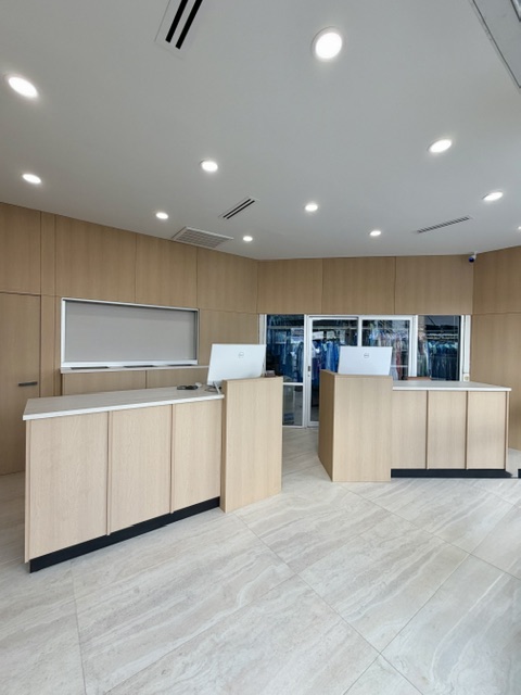 The newly remodeled Pro Cleaners reception with both light wood counters and stone flooring
